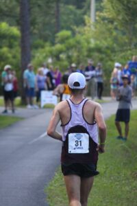 A person running on a road Description automatically generated