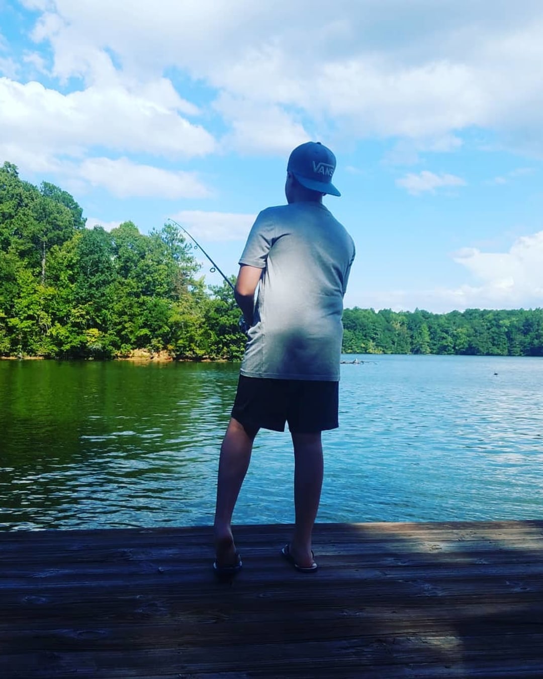 man fishing off a dock
