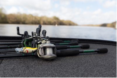 close up of fishing poles with lake in background